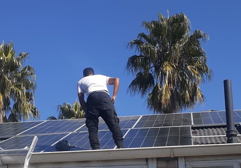 Man cleaning solar panels in Johannesburg